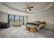 Bedroom with a ceiling fan, large windows, carpeted floor, area rug, and furniture at 2955 Pleasant Valley Trl, Cumming, GA 30028