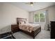 Bedroom with carpet, a large window, and dark wood furniture with a brown, red, and cream quilt at 2955 Pleasant Valley Trl, Cumming, GA 30028