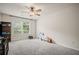 Well-lit bedroom features plush gray carpet, a large window and neutral wall color at 2955 Pleasant Valley Trl, Cumming, GA 30028