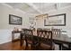 Formal dining room features a coffered ceiling, hardwood floors, and an elegant chandelier at 2955 Pleasant Valley Trl, Cumming, GA 30028