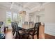 Bright dining room boasts coffered ceiling, hardwood floors and large windows with backyard views at 2955 Pleasant Valley Trl, Cumming, GA 30028
