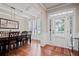 Bright dining room featuring hardwood floors, white trim, and a stylish light fixture at 2955 Pleasant Valley Trl, Cumming, GA 30028