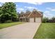 Charming two-story brick home with a lush green lawn and two-car garage at 2955 Pleasant Valley Trl, Cumming, GA 30028