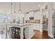 Bright kitchen features white cabinets, granite countertops, stainless steel appliances, and pendant lighting at 2955 Pleasant Valley Trl, Cumming, GA 30028