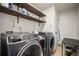 Well-organized laundry room with modern washer/dryer, shelving, and functional design for efficiency at 2955 Pleasant Valley Trl, Cumming, GA 30028