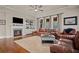 Cozy living room features a fireplace, hardwood floors, and comfortable seating at 2955 Pleasant Valley Trl, Cumming, GA 30028