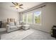 Inviting living room with a plush sofa, a textured rug, and lots of natural light at 2955 Pleasant Valley Trl, Cumming, GA 30028