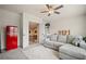 Well-designed living room with a cozy sectional sofa, unique refrigerator, and ample natural light at 2955 Pleasant Valley Trl, Cumming, GA 30028