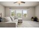 Comfortable living room featuring a gray sofa and natural light from the large windows with blinds at 2955 Pleasant Valley Trl, Cumming, GA 30028