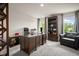 Spacious home office with dark wood furniture, shelving and plush carpet with ample natural light at 2955 Pleasant Valley Trl, Cumming, GA 30028