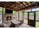 Inviting screened porch with a stone fireplace, comfortable seating, and outdoor views at 2955 Pleasant Valley Trl, Cumming, GA 30028