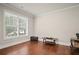 Bright room featuring hardwood floors, white trim, and a large window at 2955 Pleasant Valley Trl, Cumming, GA 30028