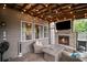 Cozy screened-in porch with a fireplace and TV, perfect for outdoor entertainment and relaxation at 2955 Pleasant Valley Trl, Cumming, GA 30028