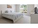 Bright bedroom featuring a large window, a comfortable bed, and a matching dresser at 3259 Mcever Park Cir, Acworth, GA 30101