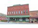 Historic brick building with green awning, vintage Coca-Cola advertisement, and street view at 3259 Mcever Park Cir, Acworth, GA 30101