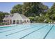 A pristine community pool is surrounded by plenty of chairs and trees in the background at 3259 Mcever Park Cir, Acworth, GA 30101