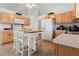 Bright kitchen with wooden cabinets, white appliances, and an island with seating at 3259 Mcever Park Cir, Acworth, GA 30101