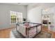 Sunny living room with hardwood floors and a play area near a bright window at 3259 Mcever Park Cir, Acworth, GA 30101