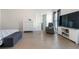 Large main bedroom featuring wood floors, a tv stand, and a comfortable gray lounge chair at 3259 Mcever Park Cir, Acworth, GA 30101