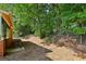 This backyard features a brick patio and a lush, shady tree line at 373 Dixie Ct, Lawrenceville, GA 30046
