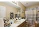 This bathroom features a vanity sink, an over-the-toilet storage unit, and a shower-tub combo at 373 Dixie Ct, Lawrenceville, GA 30046