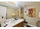 This bathroom features warm neutral tones, vanity storage, and decorative mirrors at 373 Dixie Ct, Lawrenceville, GA 30046
