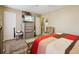 This secondary bedroom includes carpeted floors, neutral colored walls, and a comfortable armchair at 373 Dixie Ct, Lawrenceville, GA 30046
