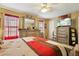 This primary bedroom features neutral tones, a ceiling fan, a dresser, and a wall-mounted TV at 373 Dixie Ct, Lawrenceville, GA 30046