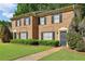 Close-up view of the brick townhome with a manicured lawn and walkway leading to the front door at 373 Dixie Ct, Lawrenceville, GA 30046