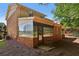 Exterior view showing sun room addition, brick elevation, and satellite dish at 373 Dixie Ct, Lawrenceville, GA 30046