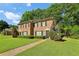 Charming brick townhome with a well-manicured lawn and mature trees in a quiet neighborhood at 373 Dixie Ct, Lawrenceville, GA 30046