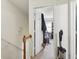 Hallway featuring view into a bedroom and a stairway with white walls at 373 Dixie Ct, Lawrenceville, GA 30046