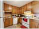 Functional kitchen with wooden cabinets, a white oven/stove, and ample countertop space at 373 Dixie Ct, Lawrenceville, GA 30046