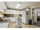 Bright kitchen features white cabinets, updated appliances, and tiled floors at 373 Dixie Ct, Lawrenceville, GA 30046