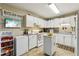 The well-lit kitchen features white cabinetry, modern appliances, and ample counter space at 373 Dixie Ct, Lawrenceville, GA 30046