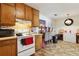 Spacious kitchen featuring vintage cabinetry, modern appliances, and an adjacent dining area at 373 Dixie Ct, Lawrenceville, GA 30046