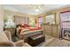 A well-furnished main bedroom featuring a ceiling fan, a neutral paint scheme, and a large bed at 373 Dixie Ct, Lawrenceville, GA 30046