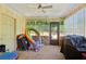 A sunroom with a ceiling fan, windows, and door to backyard at 373 Dixie Ct, Lawrenceville, GA 30046