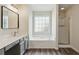 Bathroom features a soaking tub under a window, alongside a walk-in shower and vanity with a mirror at 1224 Everwood Sw Dr, Marietta, GA 30008
