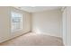 A bright bedroom with a large window and neutral carpeting, offering a calm and inviting space at 1224 Everwood Sw Dr, Marietta, GA 30008