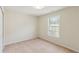 Light-filled bedroom with neutral carpet, a window, and closet, providing a comfortable and functional space at 1224 Everwood Sw Dr, Marietta, GA 30008