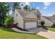 Charming two-story home with brick and siding, an attached garage, and a well-manicured lawn at 1224 Everwood Sw Dr, Marietta, GA 30008