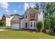 Two-story home with a brick and siding, an attached garage, and a landscaped front yard at 1224 Everwood Sw Dr, Marietta, GA 30008