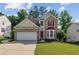Charming two-story home with brick and siding, a red door, and a well-manicured lawn at 1224 Everwood Sw Dr, Marietta, GA 30008