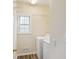 Bright laundry room featuring a white washer and dryer, plus wire shelving and a window at 1224 Everwood Sw Dr, Marietta, GA 30008