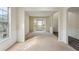 Open-concept living room with large windows and neutral-toned carpet at 1224 Everwood Sw Dr, Marietta, GA 30008