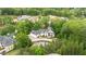 Estate aerial view showcasing manicured grounds with mature trees, complemented by a circular driveway at 1285 Stuart Rdg, Johns Creek, GA 30022