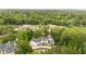 Aerial view showing neighborhood home surrounded by lush green trees at 1285 Stuart Rdg, Johns Creek, GA 30022