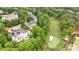 An aerial perspective of a house situated alongside a golf course, featuring mature trees at 1285 Stuart Rdg, Johns Creek, GA 30022
