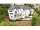 Aerial view of home with pool, stone terrace, luscious landscaping, and circular driveway at 1285 Stuart Rdg, Johns Creek, GA 30022